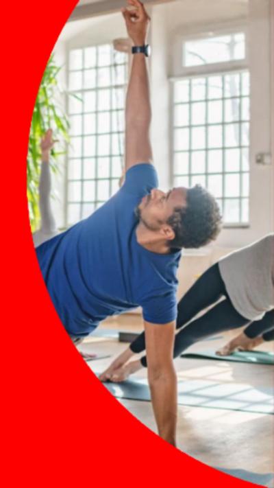 A man in a blue t-shirt doing yoga